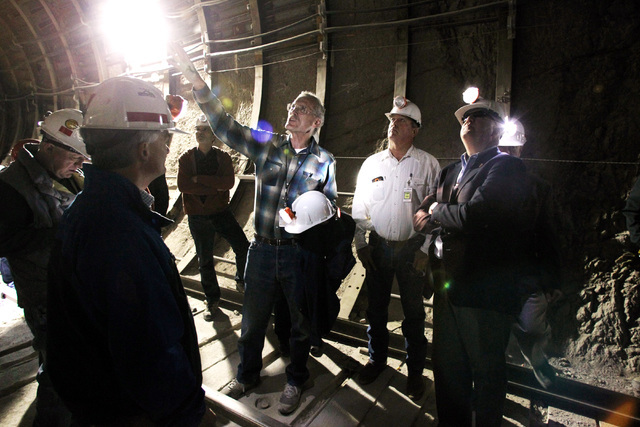 Department of Energy geologist William Boyle points out tunnel features to U.S. Rep. Jerry McNearny, D-Calif., left, Rep. Cresent Hardy, R-Nev. and Rep John Shimkus, R-Ill. during a congressional  ...