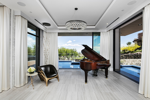 A piano room on the main level of the home is surrounded by water features and views of the Strip. (Courtesy of Shapiro & Sher Group)