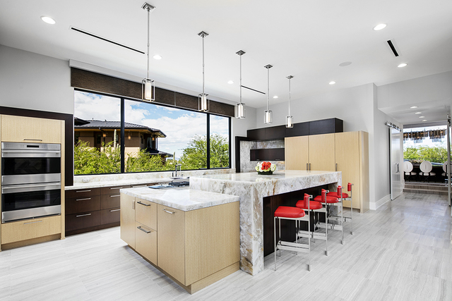 Quartzite countertops and the custom birch maple cabinets adorn the main-floor kitchen. (Courtesy of Shapiro & Sher Group)