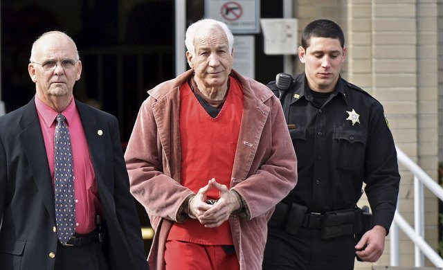 Convicted child molester Jerry Sandusky (C), a former assistant football coach at Penn State University, leaves after his appeal hearing at the Centre County Courthouse in Bellefonte, Pennsylvania ...