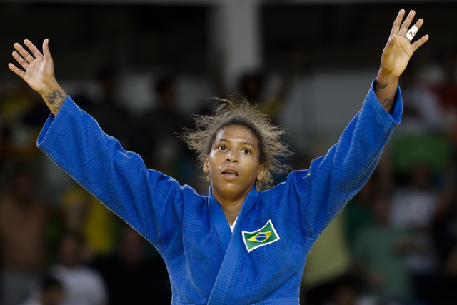 Brazil's Rafaela Silva celebrates after winning the gold medal of the women's 57-kg judo competition at the 2016 Summer Olympics in Rio de Janeiro, Brazil, Monday, Aug. 8, 2016. (AP Photo/Markus S ...