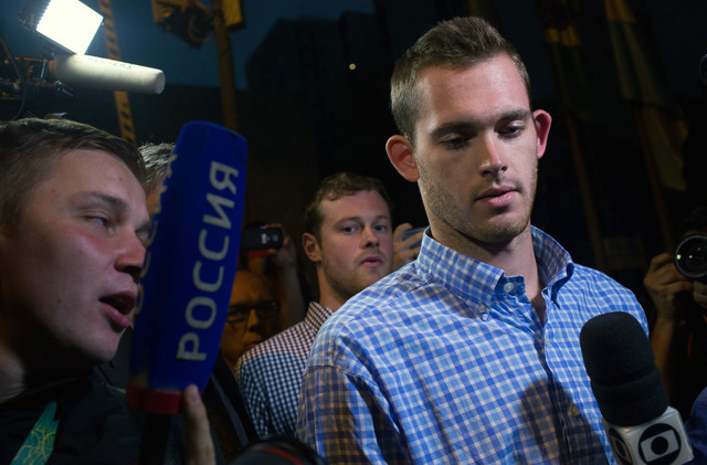 American Olympic swimmers Gunnar Bentz, right, and Jack Conger, behind, leave a police station in the Leblon neighborhood of Rio de Janeiro, Thursday, Aug. 18, 2016. (Mauro Pimentel/AP)