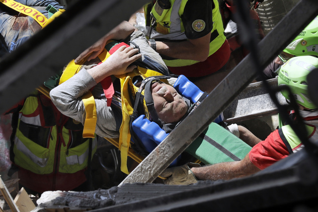 A man is rescued from the rubble of a building after an earthquake, in Accumoli, central Italy, Wednesday, Aug. 24, 2016. (Andrew Medichini/AP)