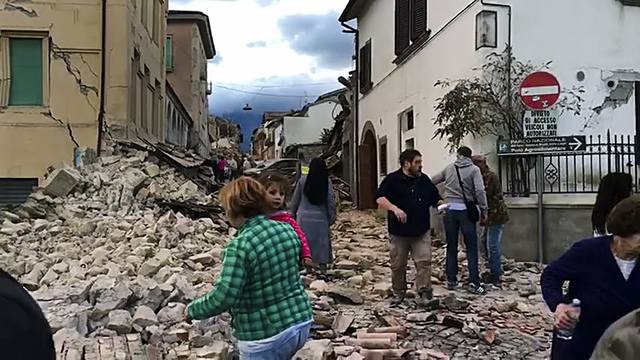 This still image taken from video shows survivors and rescuers wandering in the center of Amatrice, central Italy, where a 6.1 earthquake struck just after 3:30 a.m., Wednesday, Aug. 24, 2016. (AP ...