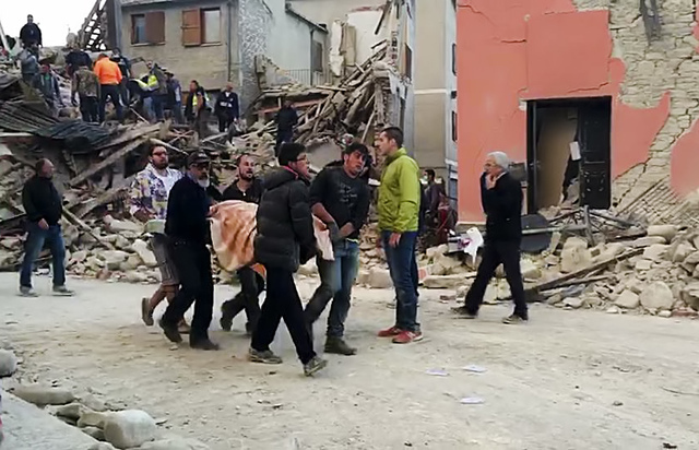 This still image taken from video shows rescuers recover a victim from a crumbled building in Amatrice, central Italy, where a 6.1 earthquake struck just after 3:30 a.m., Wednesday, Aug. 24, 2016. ...