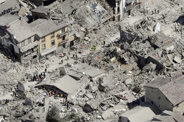 Rescuers search amid rubble following an earthquake in Amatrice Italy, Wednesday, Aug. 24, 2016. The magnitude 6 quake struck at 3:36 a.m. and was felt across a broad swath of central Italy. (AP P ...