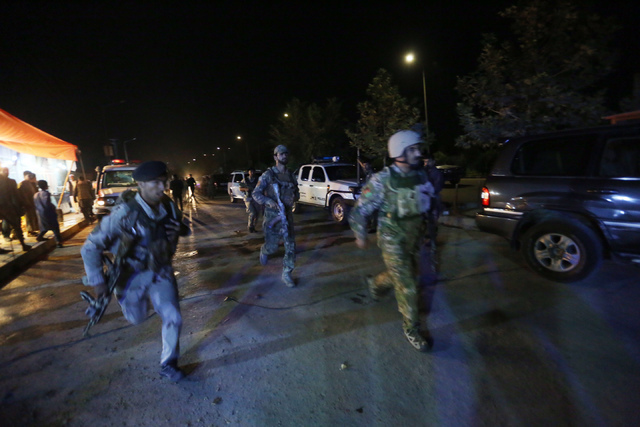 Afghan security forces rush to respond to a complex Taliban attack on the campus of the American University in the Afghan capital Kabul on Wednesday, Aug. 24, 2016. (Rahmat Gul/AP)