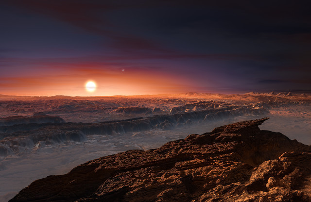 This artist rendering provided by the European Southern Observatory shows a view of the surface of the planet Proxima b orbiting the red dwarf star Proxima Centauri, the closest star to the Solar  ...