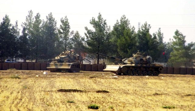Turkish army tanks are stationed near the border with Syria, in Karkamis, Turkey, Wednesday, Aug. 24, 2016. (AP)