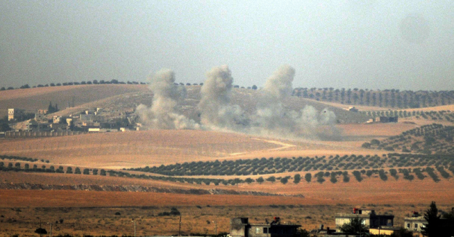 Smokes billow in Syrian side, pictured from Karkamis, Turkey, Wednesday, Aug. 24, 2016. Turkey's military and the U.S.-backed coalition forces on Wednesday launched an operation to clear a Syrian ...