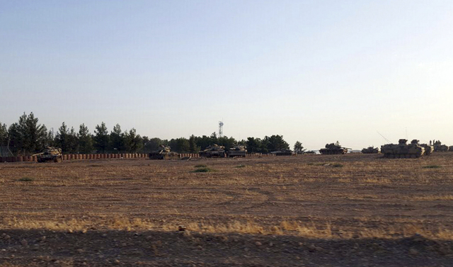 Turkish army tanks are stationed near the border with Syria, in Karkamis, Turkey, Tuesday, Aug. 23, 2016. (AP)