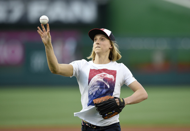 Olympic gold-medal swimmer Katie Ledecky throws out the ceremonial first pitch before a baseball game between the Baltimore Orioles and the Washington Nationals, Wednesday, Aug. 24, 2016, in Washi ...