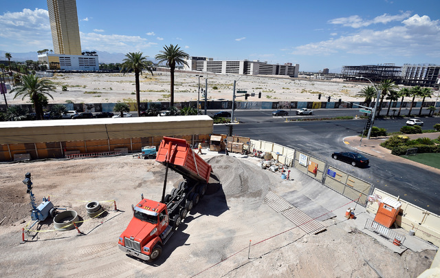 A dump truck is seen emptying its load of material at the Wynn Las Vegas retail expansion site across the Strip from the planned $2 billion Alon project Monday, Aug. 29, 2016, in Las Vegas. (David ...