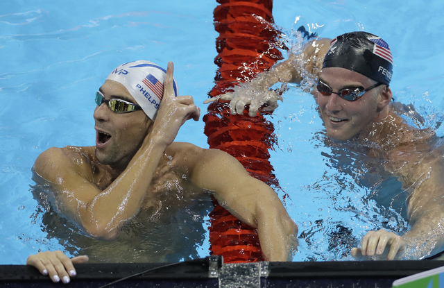 United States' Michael Phelps, left, jokes with his teammate James Feigen during a swimming training session prior to the 2016 Summer Olympics in Rio de Janeiro, Brazil, Tuesday, Aug. 2, 2016. (Ma ...