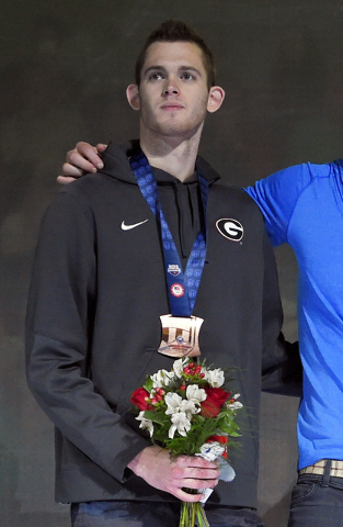 In this July 3, 2016 file photo, Gunnar Bentz stands with teammates during the men's 400-meter relay team medal ceremony at the U.S. Olympic swimming trials in Omaha, Neb. The U.S. Olympic Committ ...