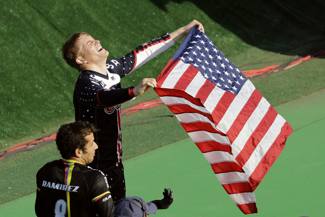 Connor Fields of the United States, top, celebrates after winning gold in the men's BMX cycling final next to third placed Carlos Ramirez Yepes of Colombia, bottom, during the 2016 Summer Olympics ...
