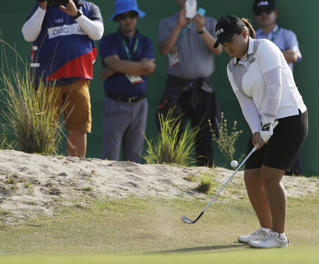 Inbee Park of South Korea attempts to reach the 14th green during the third round of the women's golf event at the 2016 Summer Olympics in Rio de Janeiro, Friday, Aug. 19, 2016. (Alastair Grant/AP)