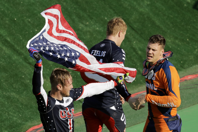 Third placed Nicholas Long of the United States, left, waves a U.S. flag next to second placed Jelle van Gorkom of the Netherlands, right, and first placed Connor Fields of the United States, cent ...
