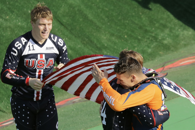 Third placed Nicholas Long of the United States, center, hugs with second placed Jelle van Gorkom of the Netherlands, right, as first placed Connor Fields of the United States, left, looks on afte ...