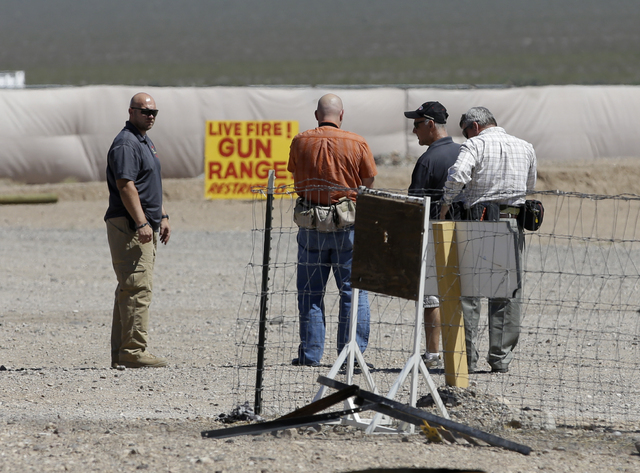 People are seen at the Last Stop outdoor shooting range Wednesday, Aug. 27, 2014, in White Hills, Ariz. Gun range instructor Charles Vacca was accidentally killed Monday, Aug. 25, 2014, at the ran ...