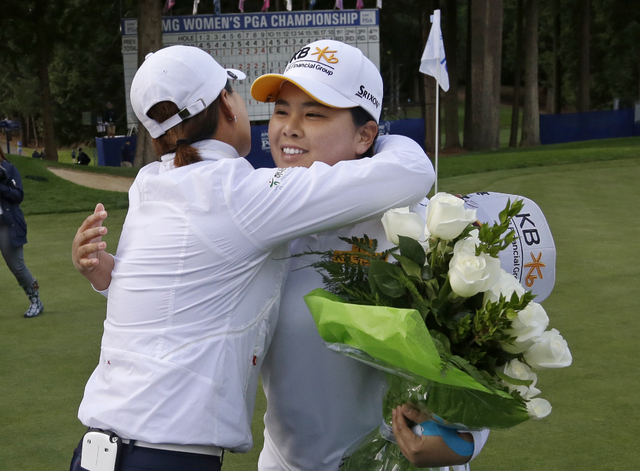 Inbee Park, right, of South Korea, is embraced after finishing the first round at the Women's PGA Championship golf tournament at Sahalee Country Club Thursday, June 9, 2016, in Sammamish, Wash. W ...
