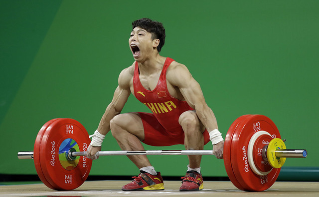 Chen Lijun, of China, competes in the men's 62kg weightlifting competition at the 2016 Summer Olympics in Rio de Janeiro, Brazil, Monday, Aug. 8, 2016. (AP Photo/Mike Groll)