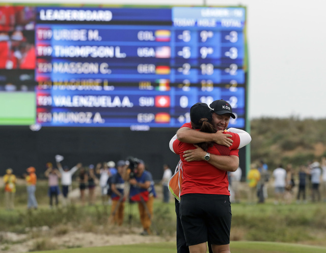 Inbee Park of South Korea, hugs her caddie after she won the gold medal during the final round of the women's golf event at the 2016 Summer Olympics in Rio de Janeiro, Brazil, Saturday, Aug. 20, 2 ...
