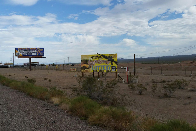 A highway sign advertises the chance to fire a machine gun at Bullets and Burgers at the Last Stop, about 25 miles south of Las Vegas. (Courtesy)