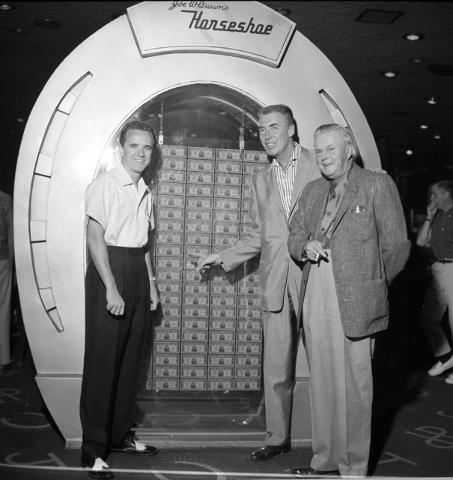 Joe W. Brown, right, poses with bandleader Art Mooney, center and another man at Binion's Horseshoe hotel-casino in front of a display of 100 $10,000 bills in this Las Vegas News Bureau photo from ...