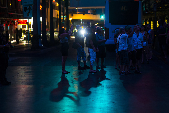 People take photos along Casino Center Avenue outside of Binion's hotel-casino, left, in downtown Las Vegas on Wednesday, Aug. 10, 2016. Chase Stevens/Las Vegas Review-Journal Follow @csstevensphoto