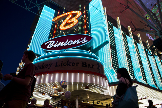 People pass the exterior of Binion's hotel-casino at Fremont Street Experience in downtown Las Vegas on Wednesday, Aug. 10, 2016. Chase Stevens/Las Vegas Review-Journal Follow @csstevensphoto