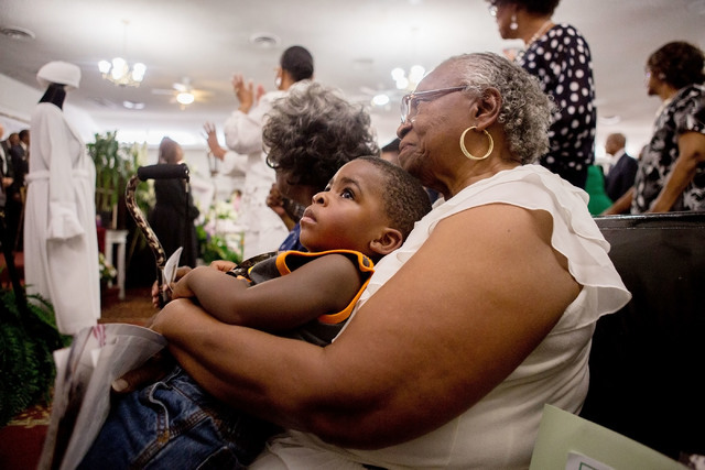 Shirley Simpson Liggins, had been friends with Mother Stella Mason Parson since she was three months old, holds her grandson T.J. Myles, 1, during Parson’s Memorial Service at Vegas View Ch ...