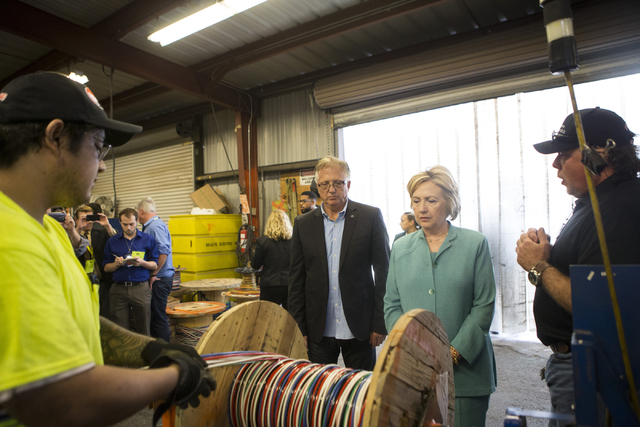 Democratic presidential nominee Hillary Clinton tours Mojave Electric with Donald Campbell, left, executive director for the Southern Nevada Chapter of the National Electrical Contractors Associat ...