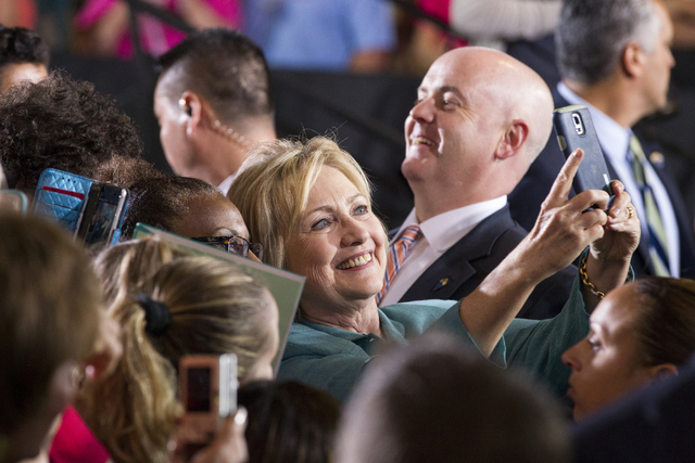 Democratic presidential candidate Hillary Clinton takes photos with supporters following her speech at a campaign rally at the International Brotherhood of Electrical Workers headquarters on Thurs ...