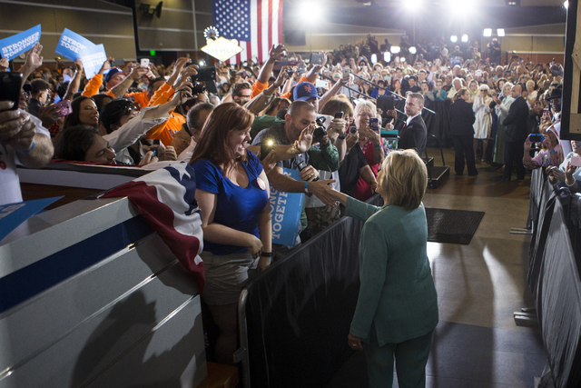 Democratic presidential candidate Hillary Clinton walks to the stage for a campaign rally at the International Brotherhood of Electrical Workers headquarters on Thursday, Aug. 4, 2016, in Las Vega ...