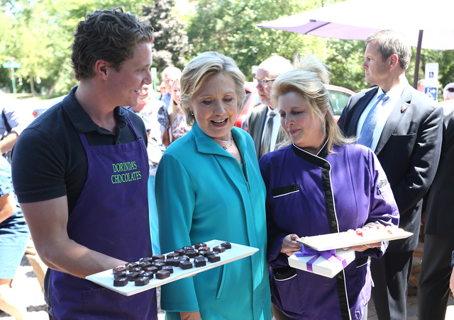 Dorindaճ Chocolateճ workers offer candy to Democratic presidential candidate Hillary Clinton during a campaign stop in Reno, Nev., Thursday, Aug. 25, 2016. Cathleen Allison/Las Vegas R ...