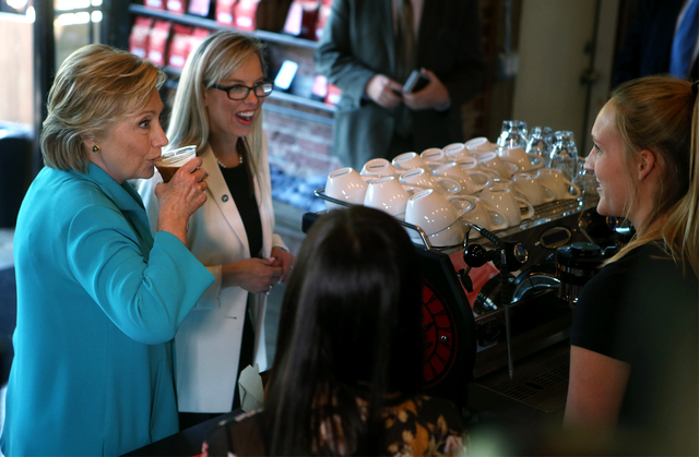 Democratic presidential candidate Hillary Clinton, left and Reno Mayor Hillary Schieve talk with Hub coffee shop workers during a campaign stop in Reno, Nev., Thursday, Aug. 25, 2016. Cathleen All ...