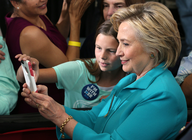 Democratic presidential nominee Hillary Clinton takes a selfie with supporter Jessica Rivera, 10, during a campaign stop at Truckee Meadows Community College in Reno, Nev., on Thursday, Aug. 25, 2 ...