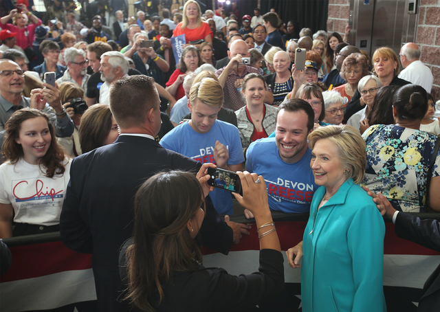 Democratic presidential nominee Hillary Clinton takes a photo with supporter Nate Helton during a campaign stop at Truckee Meadows Community College in Reno, Nev., on Thursday, Aug. 25, 2016. Cath ...