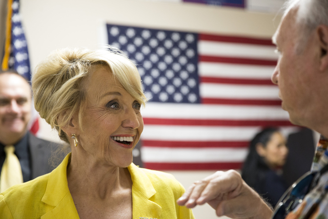 Former Arizona Gov. Jan Brewer speaks to a supporter during the grand opening for the new campaign office for Republican presidential candidate Donald Trump in Las Vegas on Saturday, Aug. 27, 2016 ...