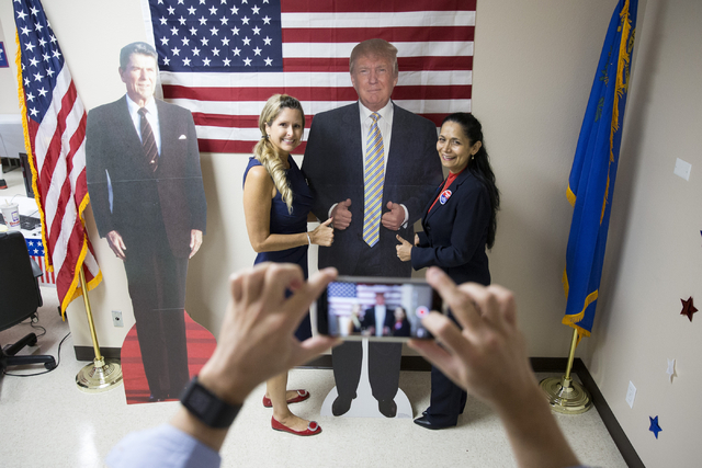 Mindy Gannon, left, and Myrian Witcher take a photo together during the grand opening for the new campaign office for Republican presidential candidate Donald Trump in Las Vegas on Saturday, Aug.  ...