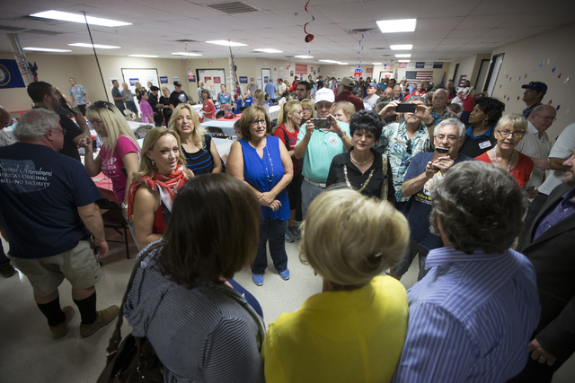 Former Arizona Gov. Jan Brewer takes photos with supporters during the grand opening for the new campaign office for Republican presidential candidate Donald Trump in Las Vegas on Saturday, Aug. 2 ...