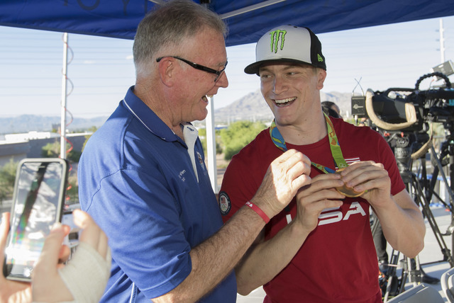BMX Olympic gold medalist Connor Fields, right, shows his medal to Henderson Mayor Andy Haffen during a celebration at the Whitney Mesa BMX Track on Tuesday, Aug. 30, 2016, in Henderson. Connor re ...