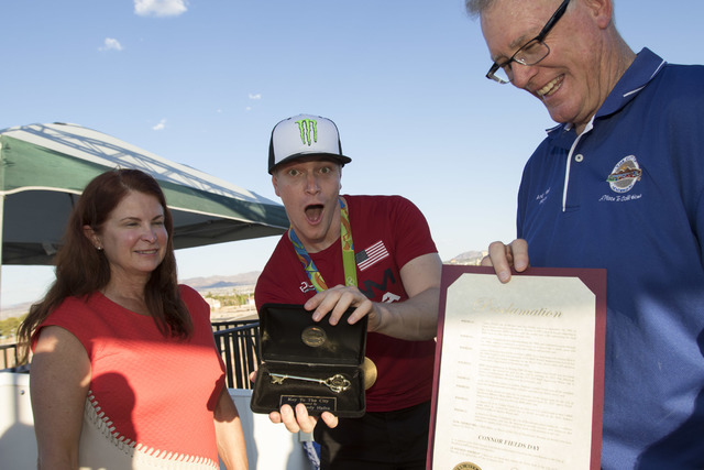 BMX Olympic gold medalist Connor Fields, center, shows off his key with Councilwoman Debra March, left, and Henderson Mayor Andy Haffen after a celebration at the Whitney Mesa BMX Track on Tuesday ...