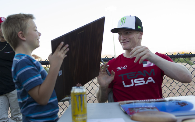 BMX Olympic gold medalist Connor Fields sign a poster for Las Vegas resident Chance Hester, 9, after a celebration at the Whitney Mesa BMX Track on Tuesday, Aug. 30, 2016, in Henderson. Connor rec ...