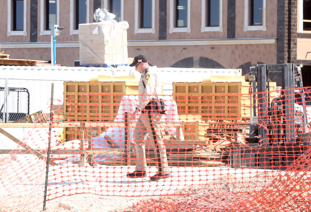A Las Vegas police officer investigates after a construction worker died after scaffolding at Tivoli Village on 302 S. Rampart Blvd., in Summerlin collapsed on Monday, Aug. 22, 2016, causing the m ...