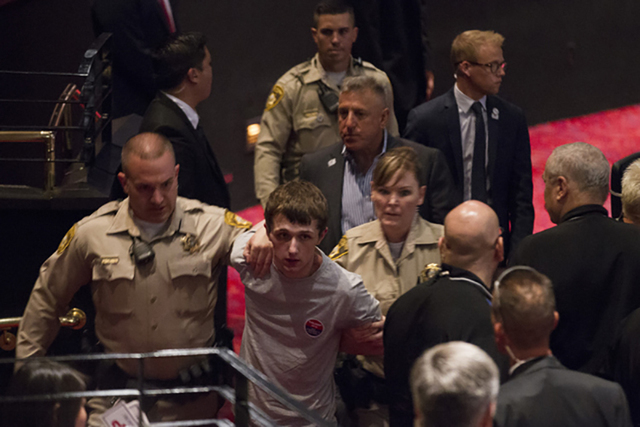 Michael Steven Sandford is escorted out of a campaign rally for Republican presidential candidate Donald Trump at the Treasure Island hotel-casino on Saturday, June 18, 2016, in Las Vegas. Erik Ve ...