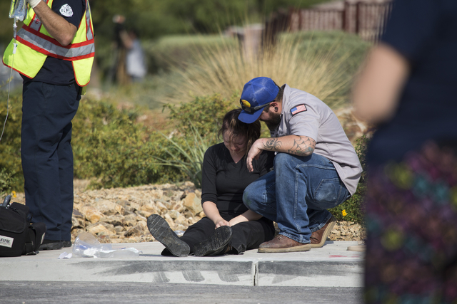 A woman is comforted at the scene of a two car crash at the intersection of North Fort Apache Road and West Lone Mountain Road is seen on Wednesday, Aug. 24, 2016, in Las Vegas. Erik Verduzco/Las  ...
