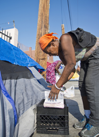 Kathy Washington, who became homeless after her home burned down five weeks ago, reads her Bible at a makeshift campsite along Foremaster Lane in downtown Las Vegas on Friday, Aug. 5, 2016. Daniel ...