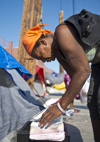 Kathy Washington, who became homeless after her home burned down five weeks ago, reads her Bible at a makeshift campsite along Foremaster Lane in downtown Las Vegas on Friday, Aug. 5, 2016. Daniel ...